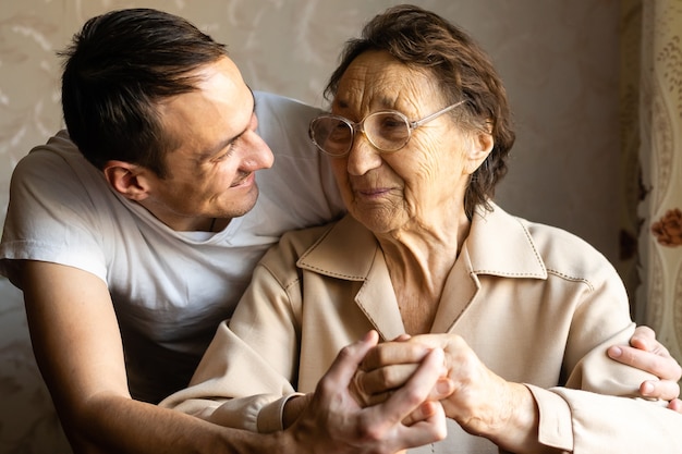 una mujer muy anciana y un nieto adulto