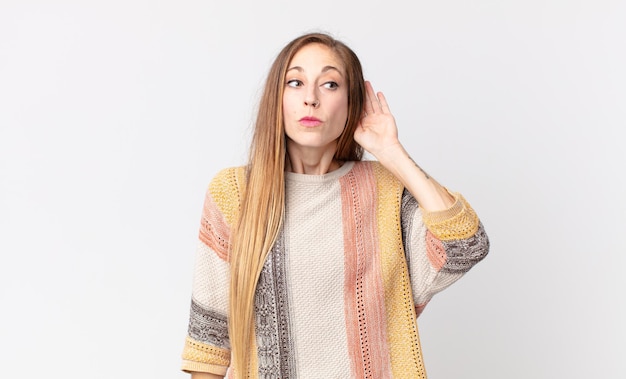 Mujer muy delgada que parece seria y curiosa, escuchando, tratando de escuchar una conversación secreta o chismes, escuchando a escondidas