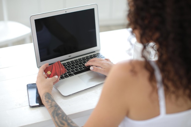 mujer navegando por internet y pagando con tarjeta