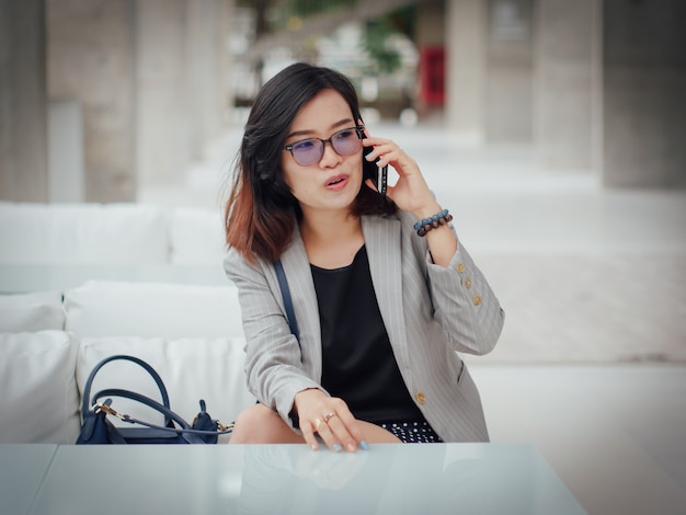 La mujer de negocios asiática feliz y el éxito del concepto de la sonrisa trabajan