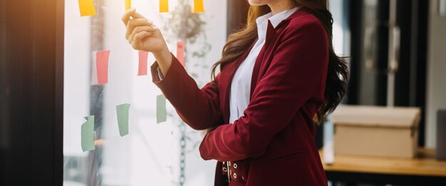 Foto mujer de negocios asiática usando calculadora y portátil para hacer finanzas matemáticas en un escritorio de oficina informe de impuestos estadísticas de contabilidad y concepto de investigación analítica