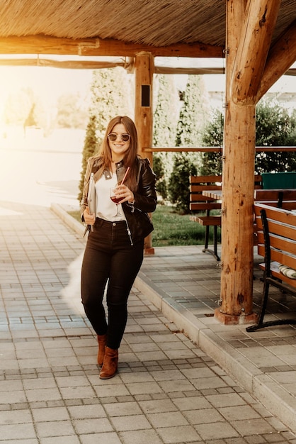 Mujer de negocios caminando por la calle con una computadora portátil