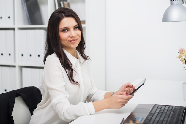 Mujer de negocios con cuaderno en el lugar de trabajo de la oficina