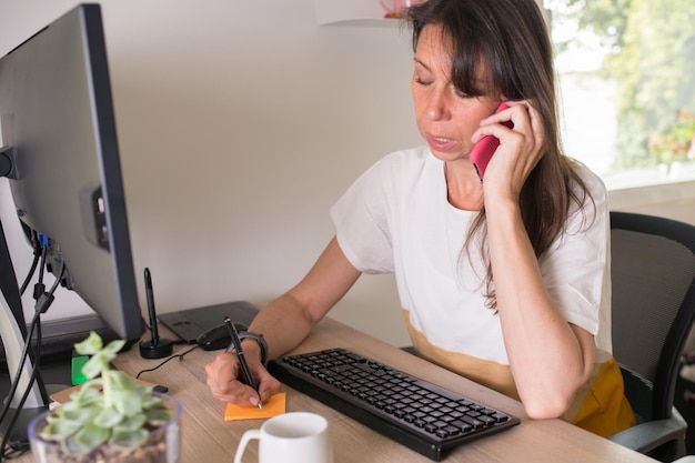 Mujer de negocios hablando por teléfono en la oficina