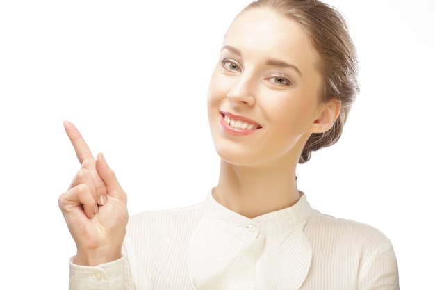 Mujer de negocios joven sonriente que muestra un área en blanco para firmar o copyspase, sobre fondo blanco