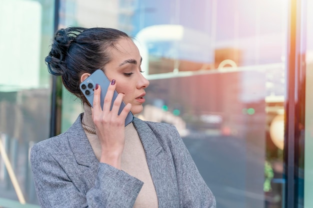 mujer de negocios o estudiante en una chaqueta y jeans usando y hablando por teléfono Tener malas noticias