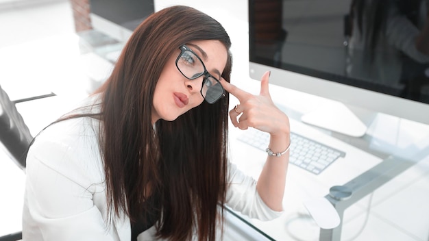 Mujer de negocios pensativa sentada en el escritorio