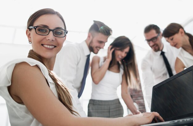 Mujer de negocios que trabaja en la computadora portátil en officephoto con espacio de copia