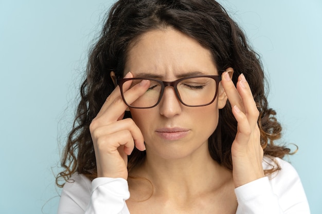 Mujer de negocios soñolienta en gafas frotándose los ojos que sufren de enfermedades oculares, fatiga ocular. Fatiga.