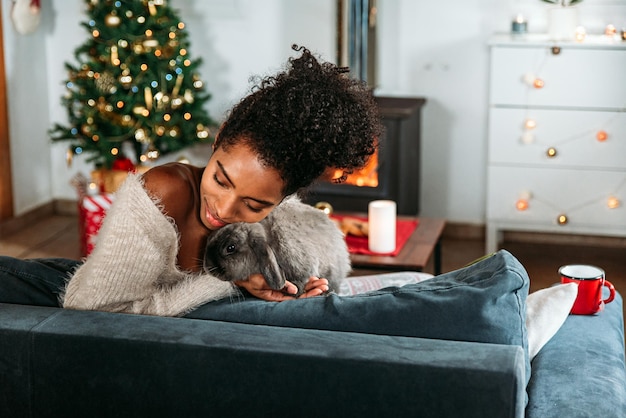 Mujer negra con conejo en Navidad