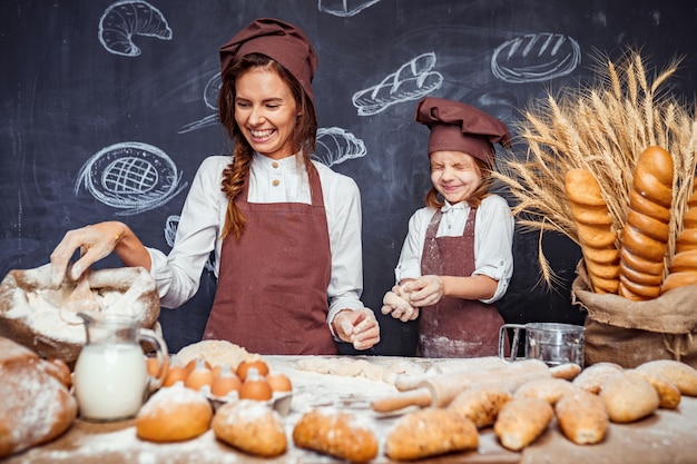 Mujer y niña haciendo pasteles juntos