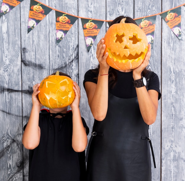 Mujer y niño con calabazas talladas