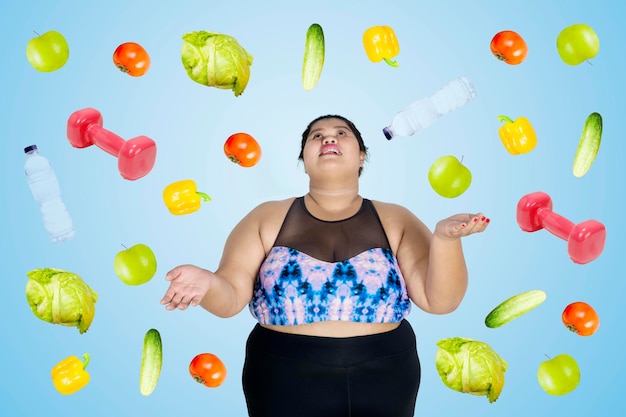 Foto mujer obesa asiática con frutas y verduras