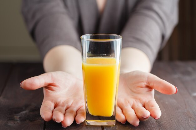 Mujer ofreciendo jugo de naranja