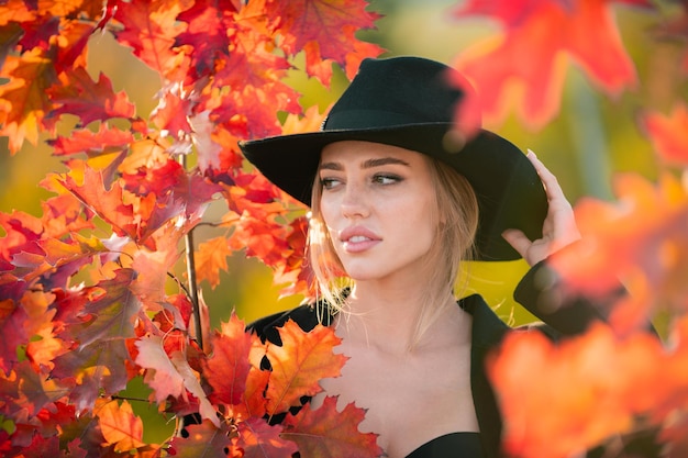 Mujer de otoño con caída de hoja de arce amarilla retrato al aire libre hermoso modelo con hojas de otoño caen ye