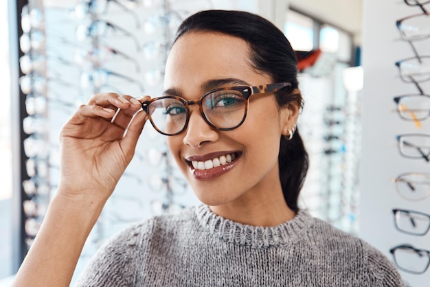 Mujer con un par de gafas de moda, gafas elegantes y nuevos lentes recetados en un optometrista Retrato de un cliente que elige comprar y comprar marcos para una mejor visión y vista