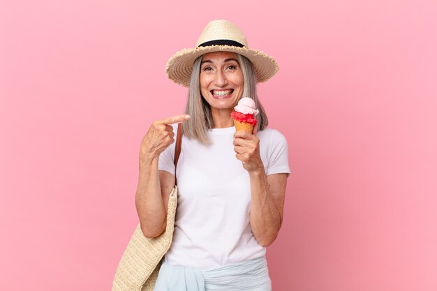 Mujer de pelo blanco de mediana edad con un helado. concepto de verano