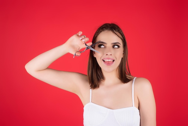 Mujer peluquera cortando el pelo con tijeras