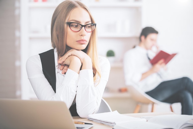 Mujer pensante en el lugar de trabajo