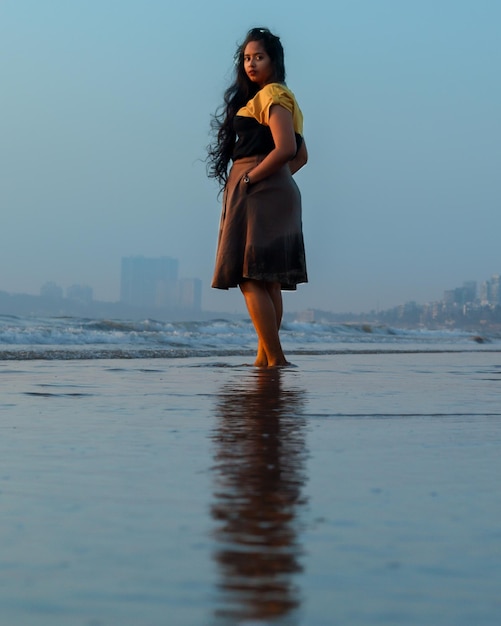 Foto mujer de pie en el mar contra el cielo