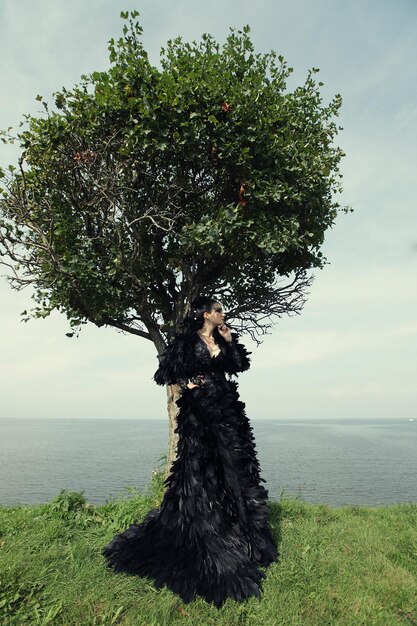 Foto mujer posando cerca del mar dark queen