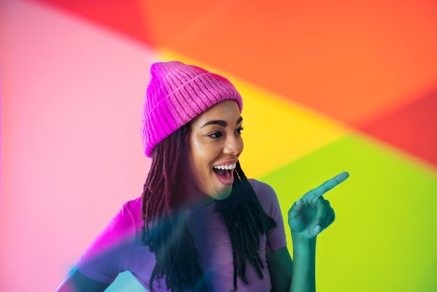 Mujer posando sobre fondos de colores en el estudio con ropa de moda