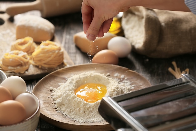 Mujer preparando pasta en la cocina, primer plano