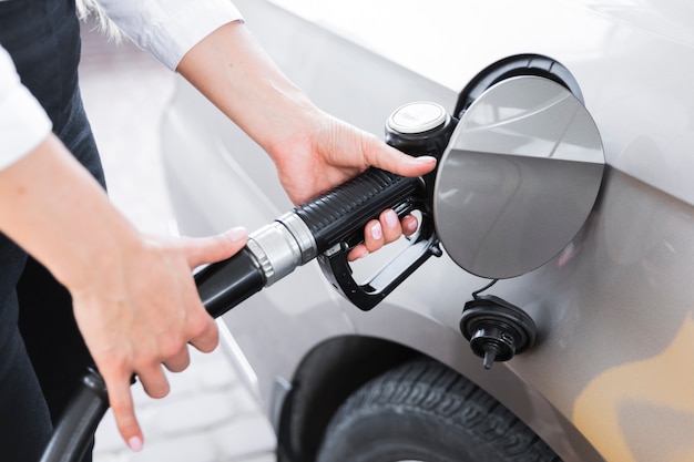 Mujer de primer plano llenando el tanque de gas