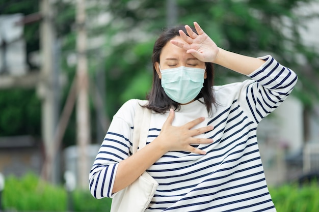 La mujer que usa una máscara facial protege el filtro contra la contaminación del aire (PM2.5) o usa N95