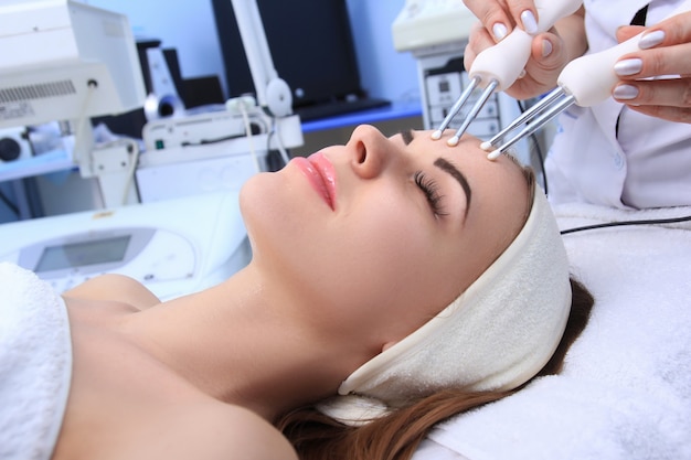 Mujer realizando procedimientos cosméticos en la clínica de spa.