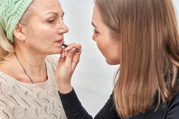 Mujer en la recepción de la esteticista aplica maquillaje.