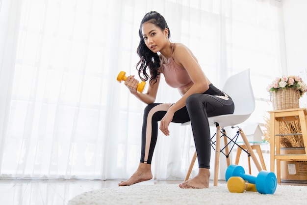 Mujer en ropa deportiva haciendo fitness en casa