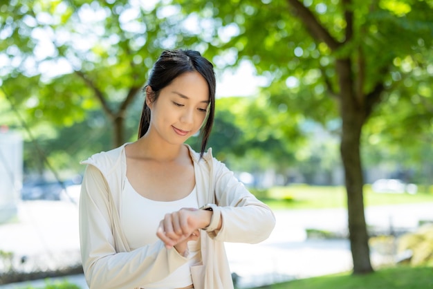 Mujer con ropa deportiva uso de reloj inteligente