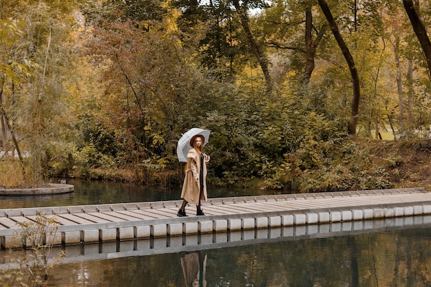 Una mujer en ropa de otoño de moda en el parque de la ciudad en otoño. fin de semana. tendencias de otoño. lugar libre para texto