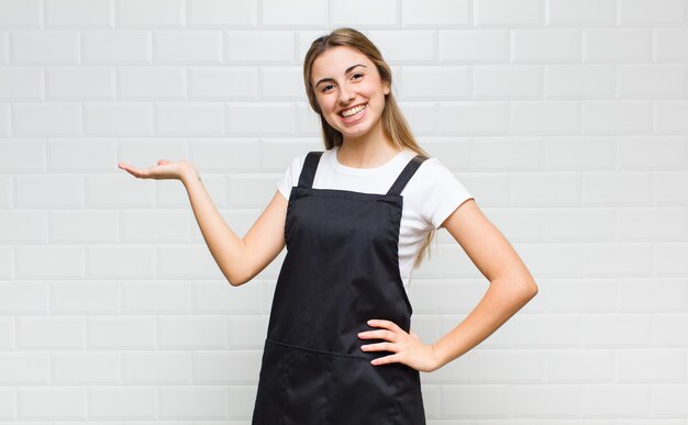 Foto mujer rubia sonriendo, sintiéndose segura, exitosa y feliz, mostrando concepto o idea