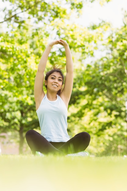 Mujer sana estirando las manos en el parque