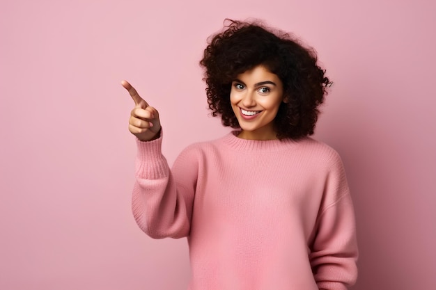 Una mujer señala algo sobre un fondo rosado