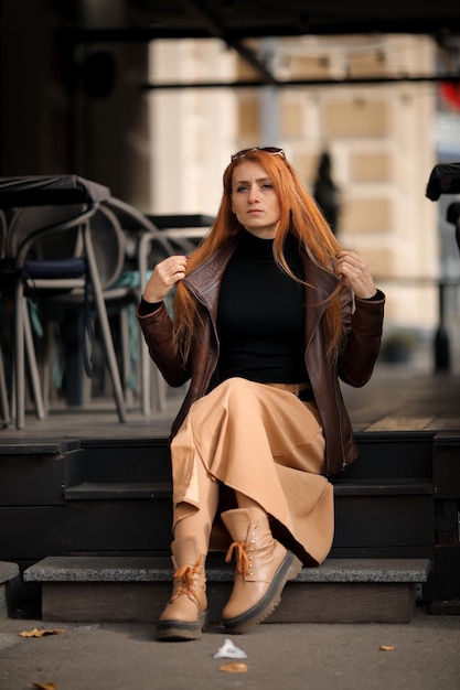 mujer sentada en los escalones de un edificio, paisaje urbano