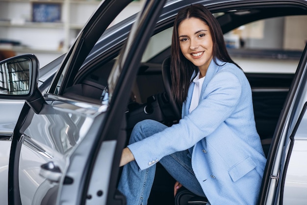 Mujer sentada en su auto nuevo