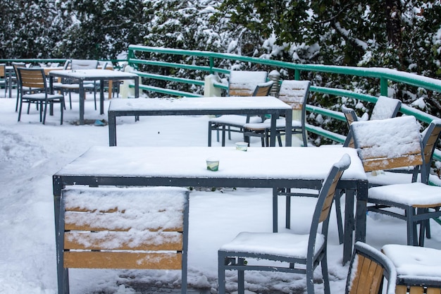 Una mujer se sienta en una mesa cubierta de nieve.