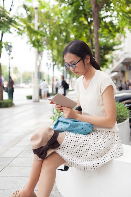 la mujer se sienta y usa el teléfono inteligente.