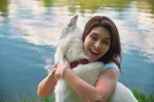 Mujer sonriente abrazando a su perro