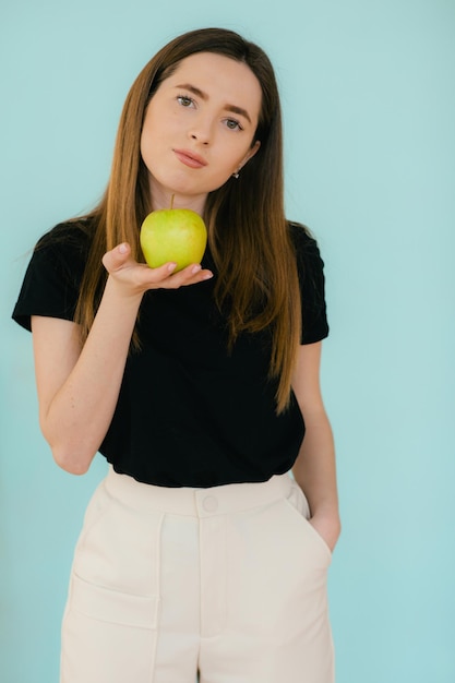 Mujer sonriente alegre sosteniendo manzana