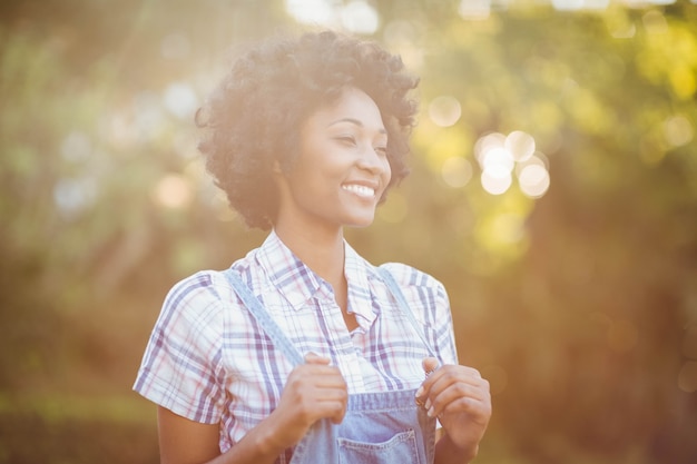 Mujer sonriente en el jardín mirando a otro lado