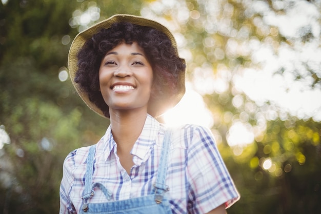 Mujer sonriente en el jardín mirando a otro lado