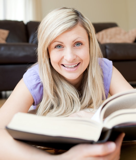 Mujer sonriente leyendo un libro