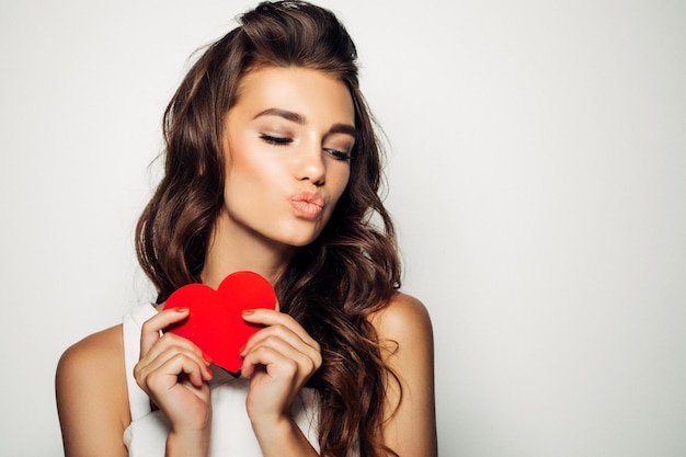 Foto mujer sonriente, tenencia, corazón rojo, amor, símbolo