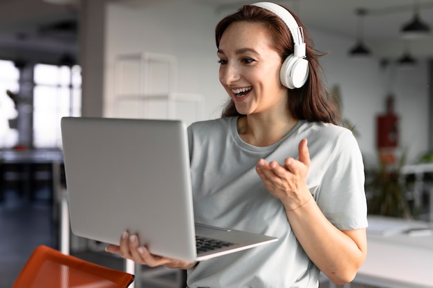 Mujer sonriente de tiro medio en videollamada