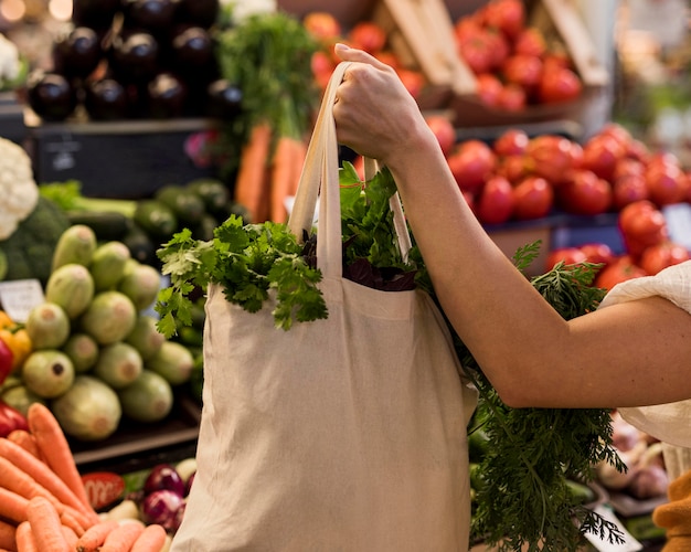 Foto mujer sosteniendo una bolsa de verduras