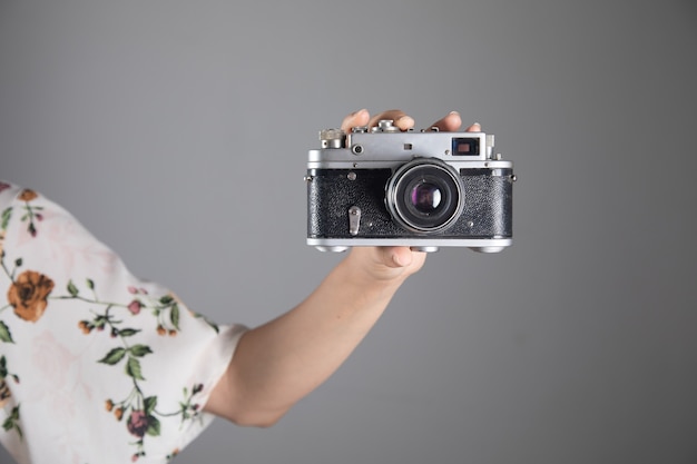 Mujer sosteniendo una cámara vintage